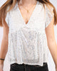 Top à sequins blanc – glow soft & chic